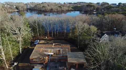 House in framing on a pond, seen from the air